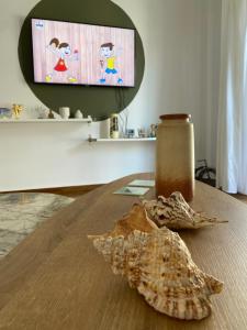 a shell sitting on a wooden table with a jar at Athens Sunnyside condo in Athens