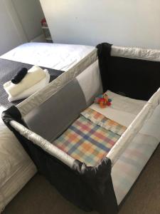 a bed frame with a quilt on top of it at SHORT WALK TO NELSON CITY CENTRE - Quiet location, comfy beds, pet friendly, full kitchen, claw-foot bath tub, outdoor areas in Nelson