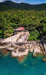 a boat is docked at a dock in the water at Bambu Huts in Baan Tai