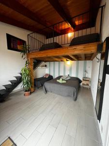 a bedroom with a bed and a loft at B&B Cascina Bedria in Ivrea