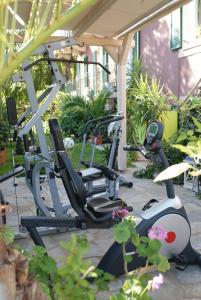 a gym with two exercise bikes on a patio at Captain's House Hotel in Skala