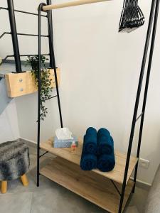 a bunk bed with blue towels on a wooden shelf at BE MY APPARTS, Studio de charme "LE CARILLON", DOUAI, Coeur de ville in Douai