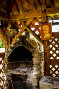 a large stone fireplace in a wooden building at Domki przy Młynie " Koło Młyńskie " in Krościenko