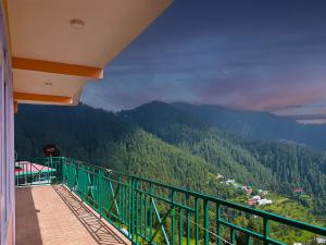 a balcony with a view of a mountain at Divine Hills Mashobra in Shimla