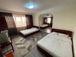 a hotel room with two beds and a room with two at Motel Orion in Obrejiţa
