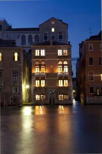 a large building in a city at night at Palazzetto Pisani Grand Canal in Venice