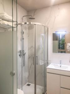 a bathroom with a shower and a sink at Rua Grande Hotel in Viana do Castelo