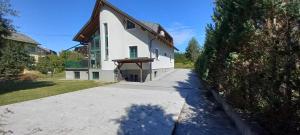 a white house with a porch and a driveway at Ferienhaus Anna Seelach in Sankt Kanzian