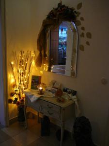 a room with a desk and a mirror with a candle at Haus Drei Tannen in Schieder-Schwalenberg