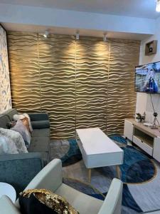 a living room with a couch and a tv at Romantic Studio Unit, Matina Enclaves Residences in Davao City