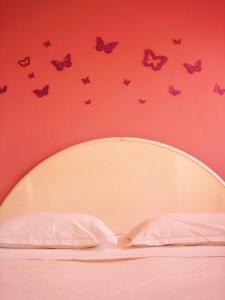 a bedroom with a bed with butterflies on the wall at Room near city center Butterfly in Split