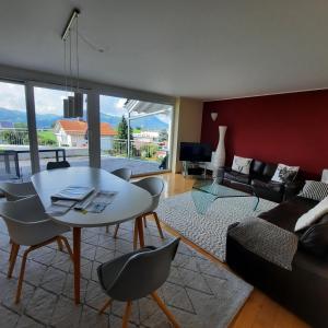 a living room with a table and chairs and a couch at Panoramablick in Rettenberg