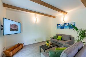 a living room with a couch and a table at B & B Il Sottobosco in Val Masino