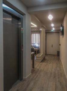 an empty room with a hallway with a desk and a table at Rua Grande Hotel in Viana do Castelo