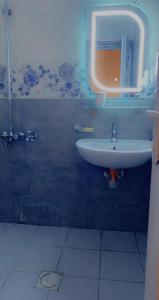 a bathroom with a sink and a mirror at Dreams Apartments شقق الاحلام in Baghdād