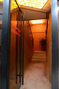 a hallway with stairs and a sign on the door at Syros Hotel Erbil City Center in Erbil