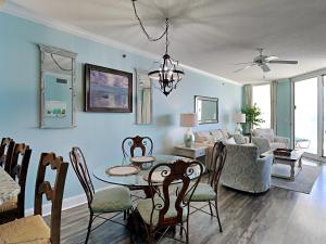 a dining room and living room with a table and chairs at Palacio #1003 in Perdido Key