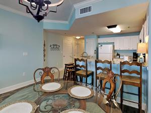 a dining room and kitchen with a table and chairs at Palacio #1003 in Perdido Key +54 photos