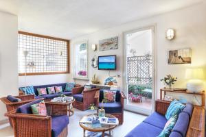 a living room with a blue couch and chairs at Hotel Yacht Club in Marciana Marina