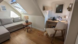 a living room with a couch and a table at Beach Lodge in Bournemouth