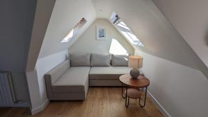 a living room with a couch and a table at Beach Lodge in Bournemouth