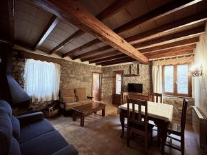 a living room with a couch and a table at Complejo Rural La Glorieta in Catí