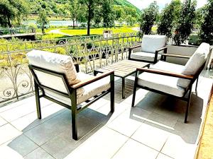 a group of chairs sitting on top of a patio at Direct Moselle view 200m² 4 SZ 10Pers Terrace in Sankt Aldegund