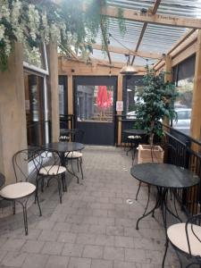 a patio with tables and chairs in a restaurant at Ravelston House in Musselburgh