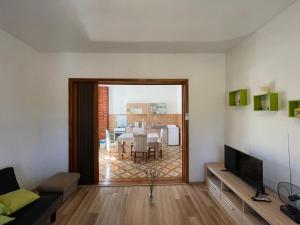 a living room with a television and a dining room at Vacation home Ivan in Kašić