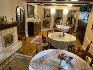 a dining room with two tables and a fireplace at Vikerkaare Villa in Tartu