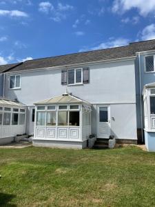 a large white house with a yard at Ploughmans Cottage, St Florence, Tenby in Saint Florence