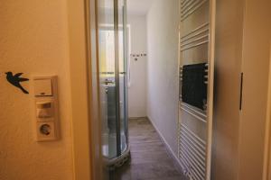 a hallway with a glass door to a room at Franzis Feriendomizil im Herzgebirge am Skihang in Auerbach +70 photos