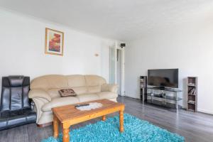 a living room with a couch and a coffee table at 10 MIN to City Centre R2 in Beeston Hill