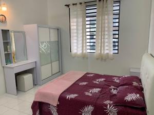 a bedroom with a bed and a mirror and a window at Homestay Maryam in Lumut