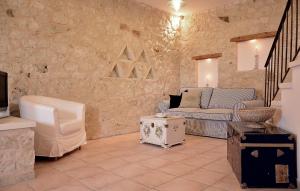 a living room with a couch and a tv at Olive Coast Suites in Palekastron