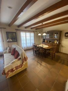 a living room with a bed and a dining room at Cal Cuaresma in Isona