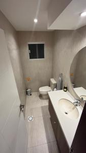 a bathroom with a white sink and a toilet at Mi casa es tu casa ! in Santa Cruz de la Sierra