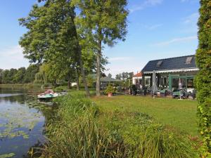 a house on the shore of a river at Hotel Grüner Baum in Genthin