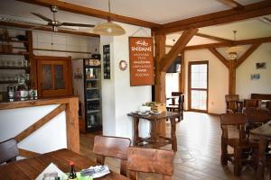a restaurant with tables and chairs in a room at Apartmán Restaurace 16 in Horka u Staré Paky
