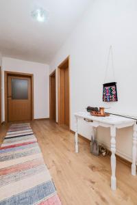 a living room with a white table and a television at Nera-etwa Konjic 2 room in Konjic