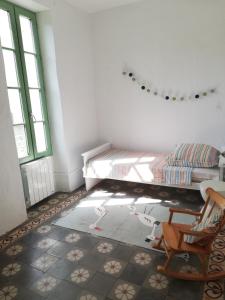 a room with a bed and a chair in it at Déjeuner au bord de l'eau in Sommières