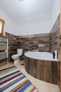a bathroom with a tub and a toilet at Nera-etwa Konjic 2 room in Konjic +16 photos