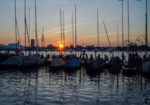 a group of boats docked in the water at sunset at Bett 4 you Hamburg-Alster in Hamburg