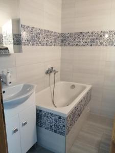 a bathroom with a bath tub and a sink at Lina in Gradac