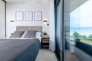 Posteľ alebo postele v izbe v ubytovaní Resort HEVENIA Rewal 3