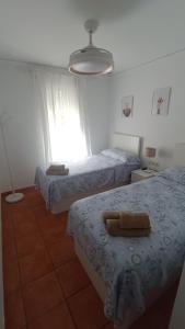 A bed or beds in a room at MET&GOLF OLIVA NOVA BEACH JARDIN