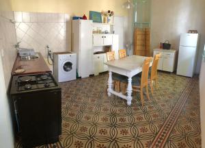 a kitchen with a table and a stove and refrigerator at Apartment Marasovic in Vis
