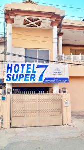 Hotel Super Seven في لاهور: علامة السوبر الفندق على جانب المبنى