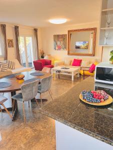 a kitchen and living room with a table with a plate of fruit at Apartments Splitska Dream in Splitska