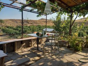 a table and chairs under a pergola on a patio at CAVE HOUSE(KIR EVİ) in Urgup